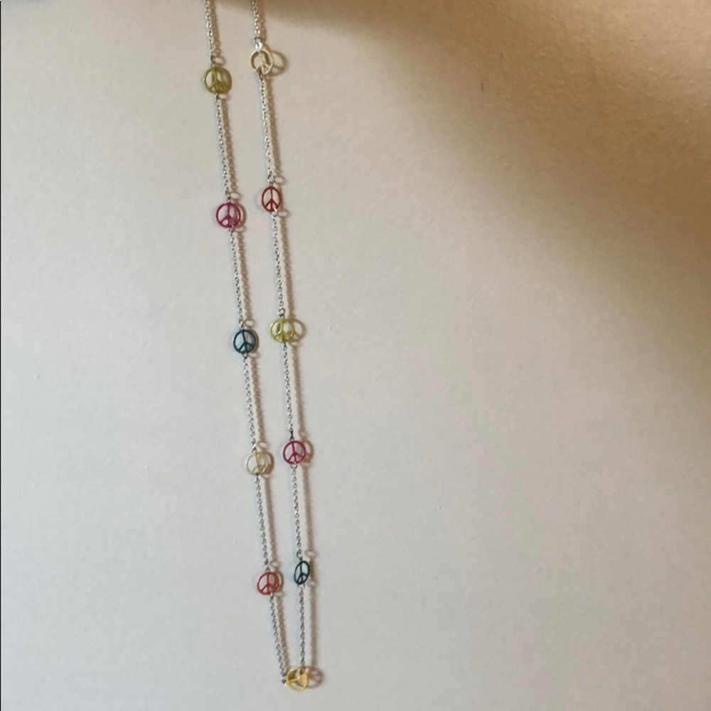 Long peace sign necklace.